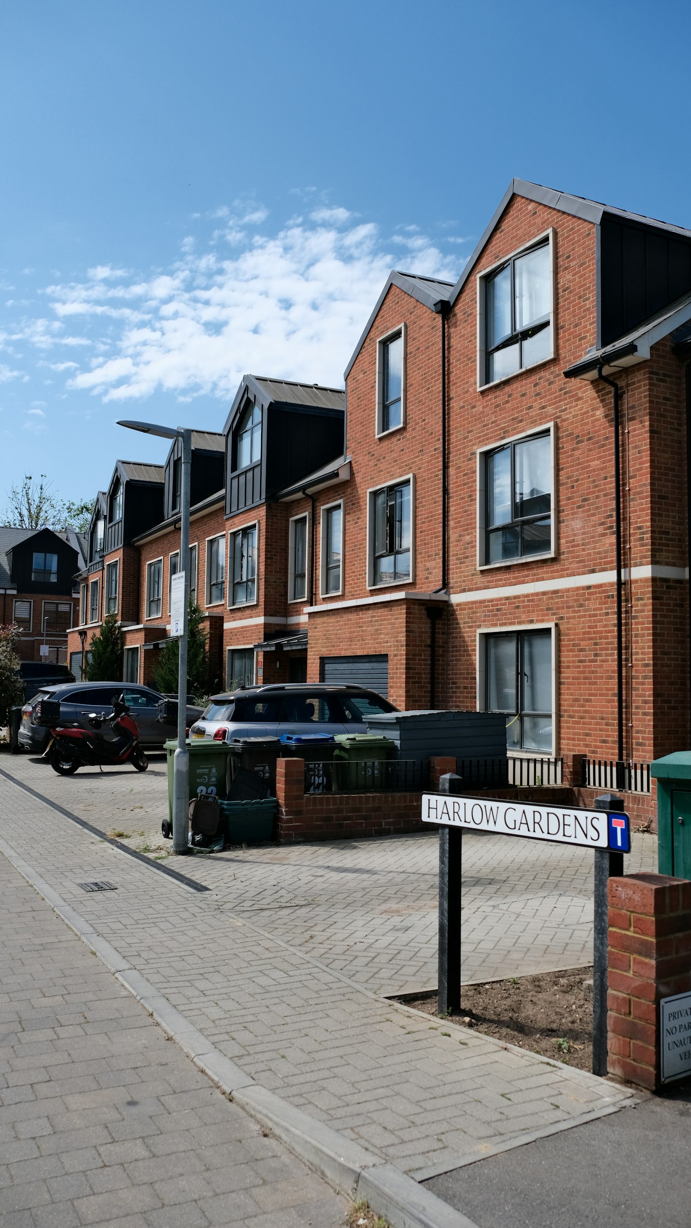 A street of brick homes with driveways